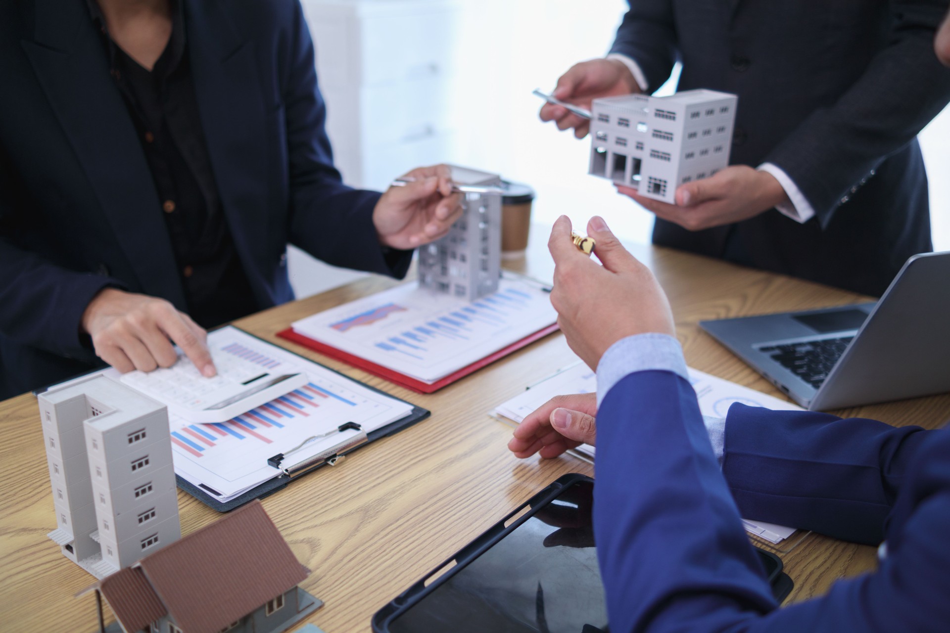 group of businessmen and investors discuss investing in real estate and jointly plan investments in construction projects of condominiums and apartments for sale and rent. investment advisory concept